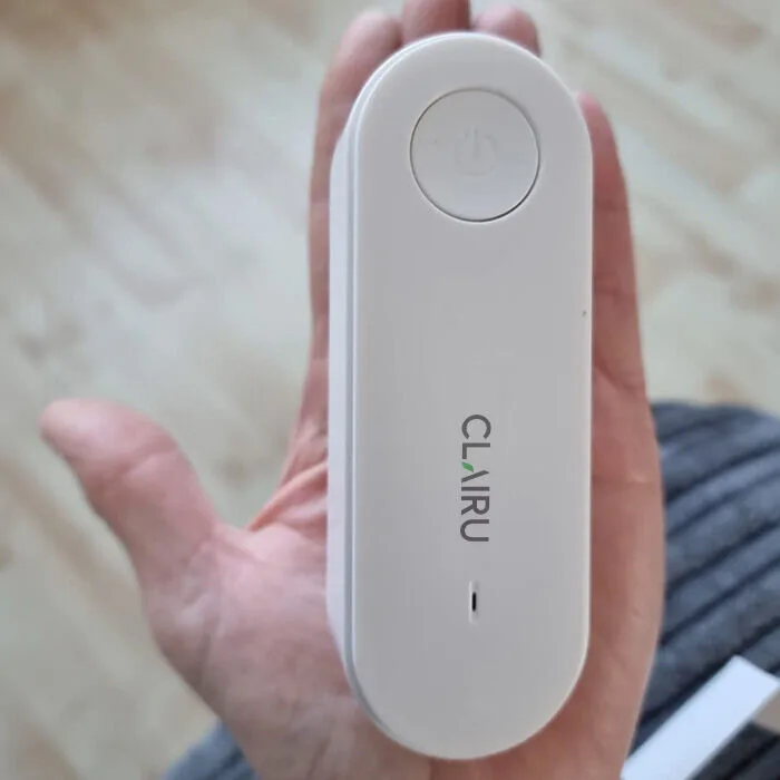 Front of the Clairu plug-in unit showing a smooth oval body with a single button and no vents or water tank