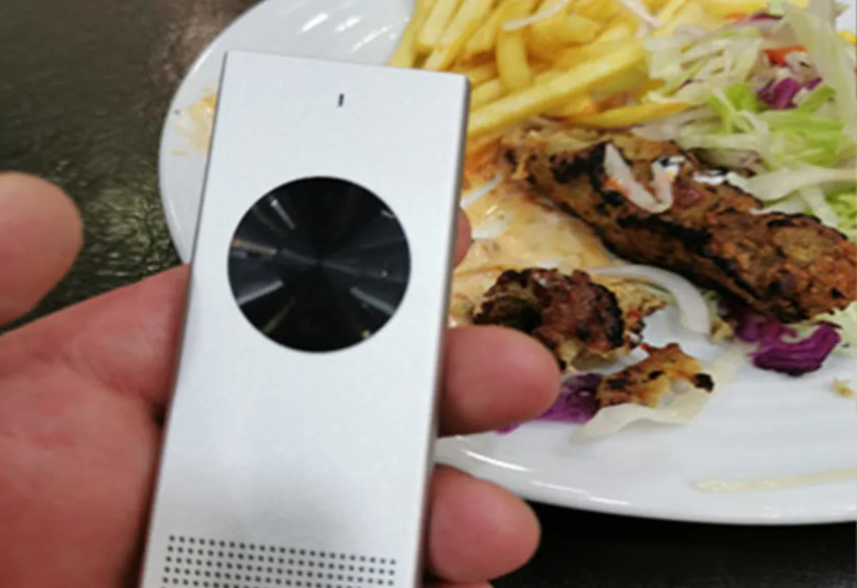 Traveler using the Enence translator to order food at a local restaurant