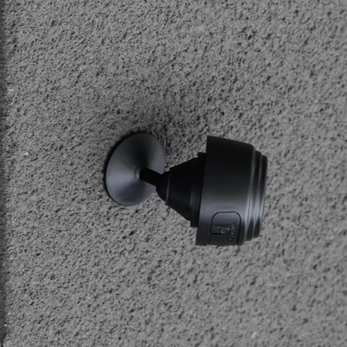 GuardHouse camera shown against a neutral background highlighting its compact magnetic body