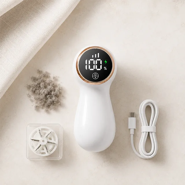 The NoFuzz charging port, power button, and removable lint chamber up close