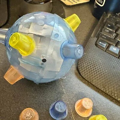 Jumping activation ball on a desk beside spare colored nubs