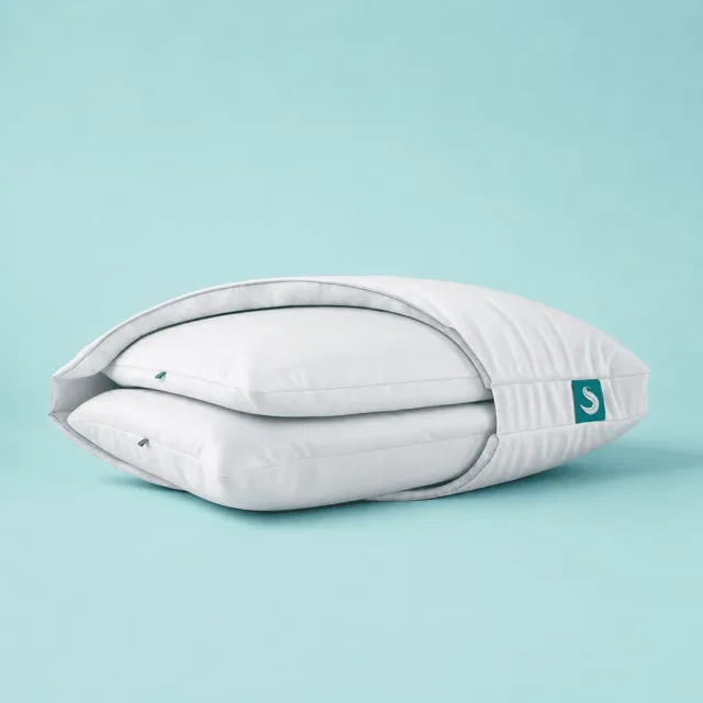 The Sleepgram pillow set up on a bed with both inserts visible for the nightly testing routine