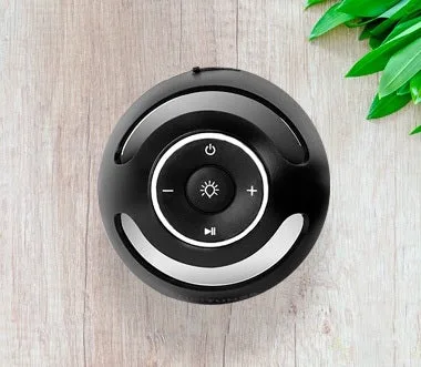 Top-down view of TikiTunes showing the three-button layout: power, volume, and light toggle